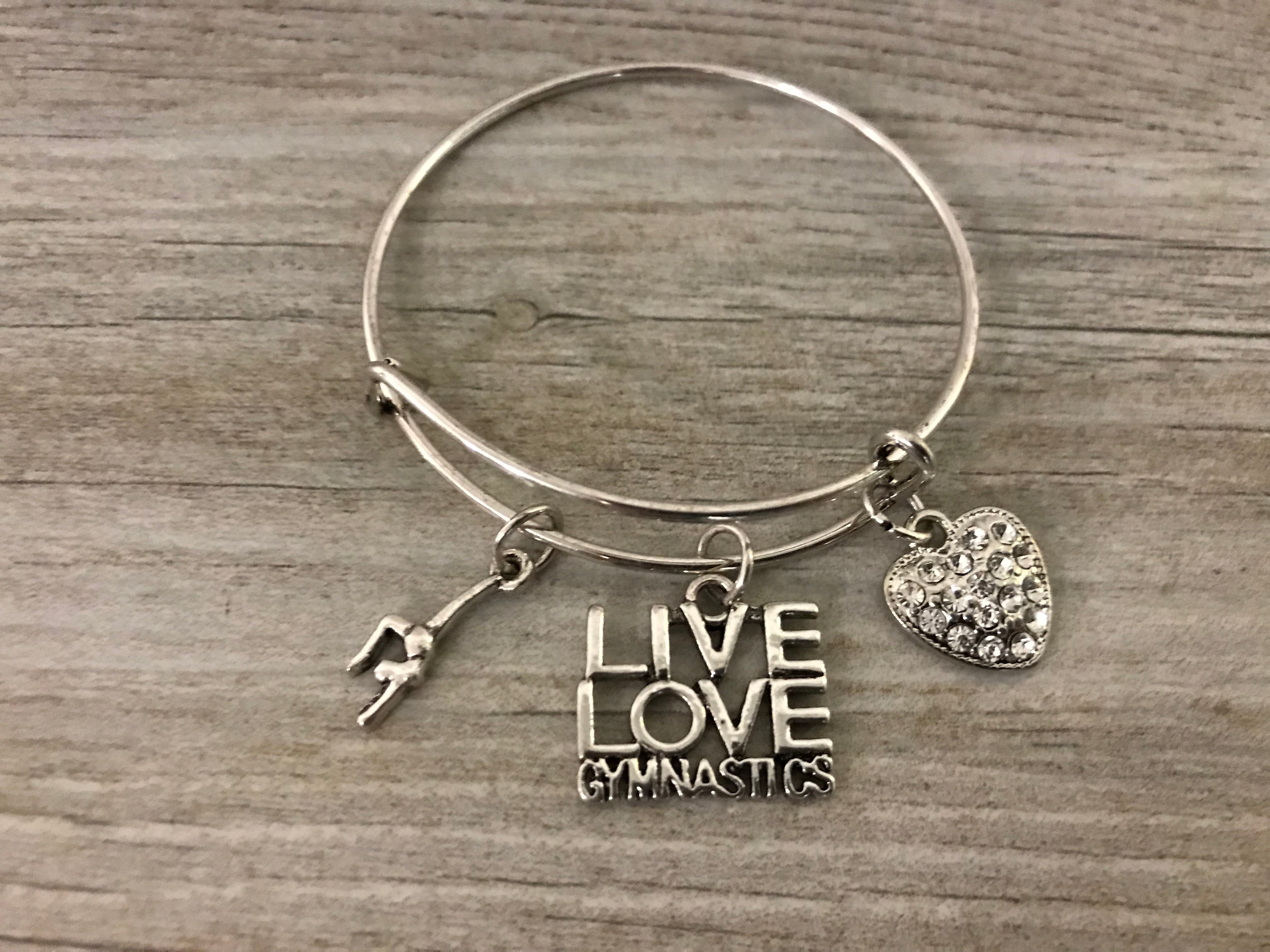 Live Love Gymnastics bangle bracelet displayed on wooden background
