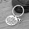 You’re Braver than You Believe figure skating keychain with ice skate charm on rustic wood background